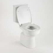 AKW white ergonomic toilet seat with lid angled view on toilet pan