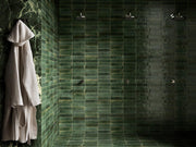 Close-up of Tampa green gloss porcelain brick tile 240x60mm showing glossy textured surface